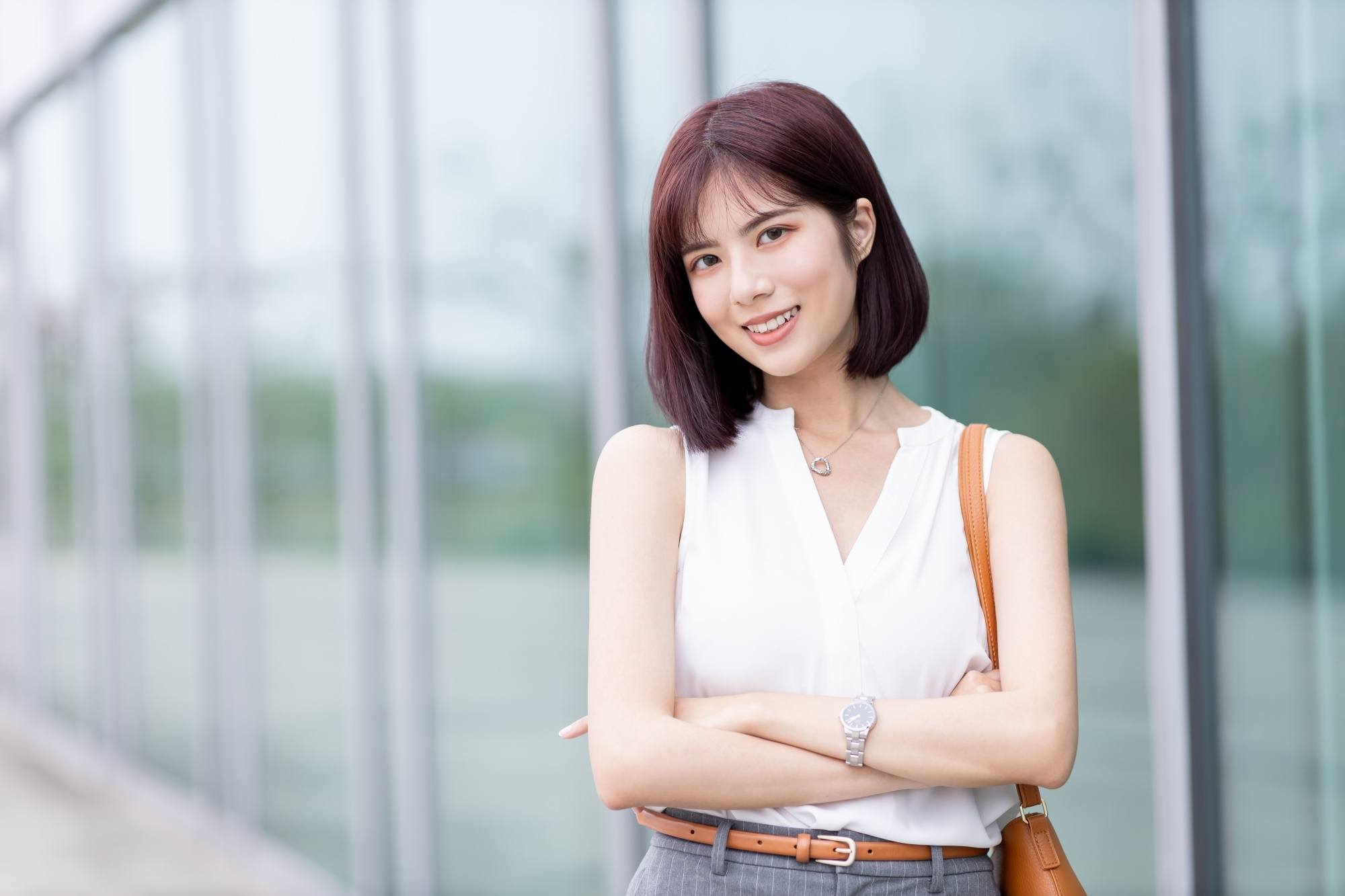Asian woman with short burgundy hair
