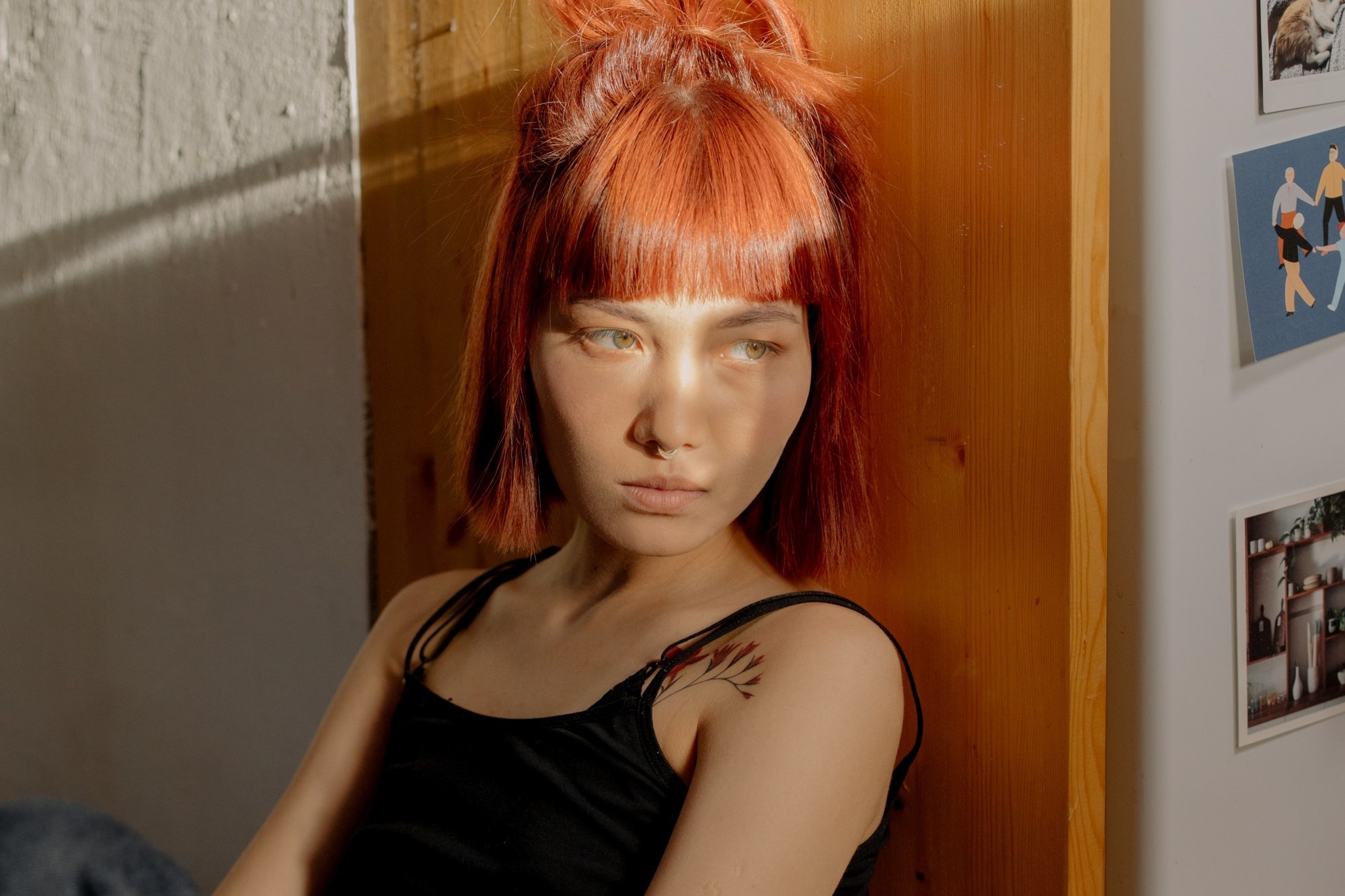 Asian woman with short ginger hair with bangs