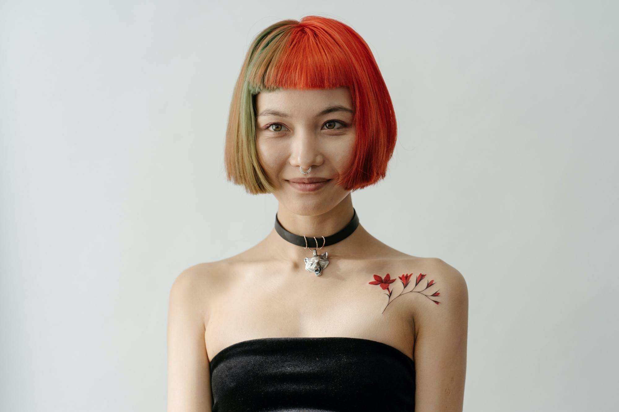 Asian woman with short hair dyed red and moss green