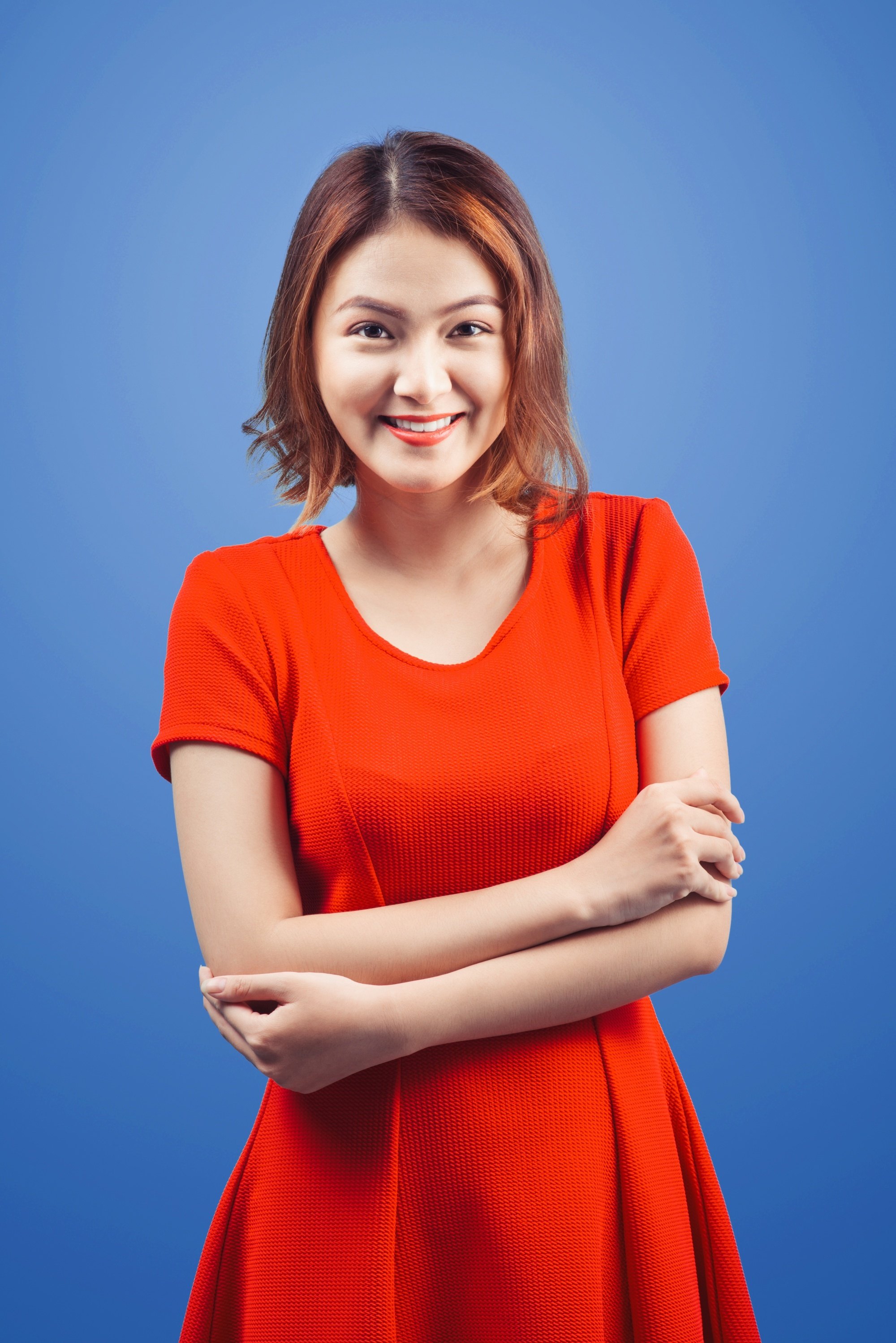 Asian woman with short copper red hair