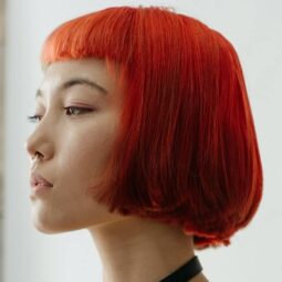 Asian woman with short red hair
