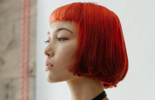 Asian woman with short red hair