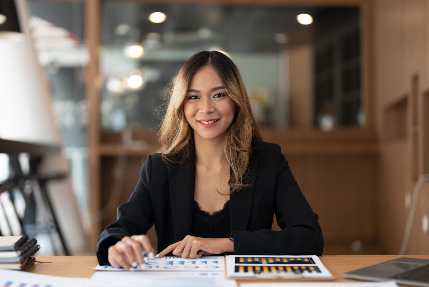 Portrait of an accountant Asian woman working and analyzing financial statements