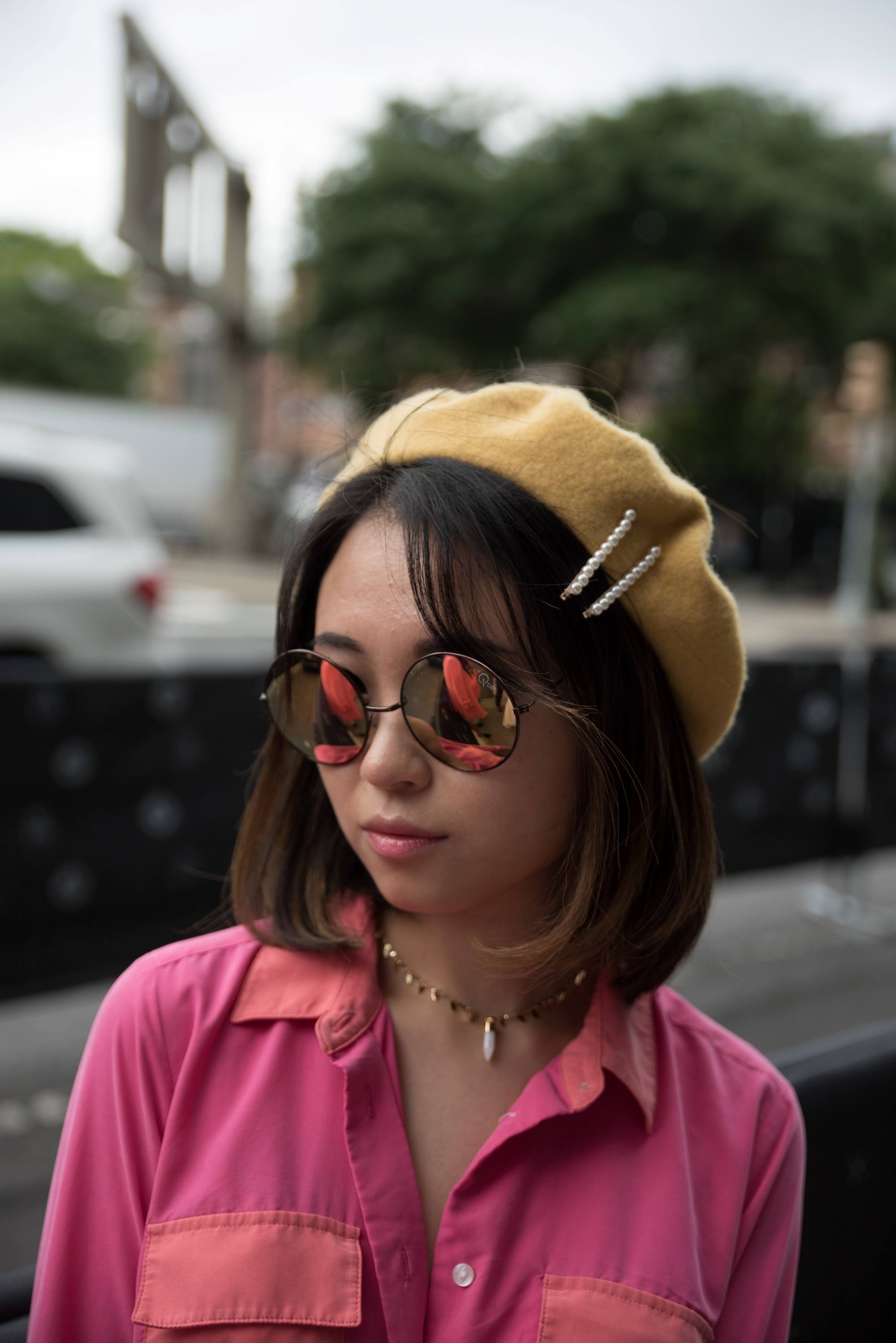 Woman with short hair wearing a yellow beret and pearl clips