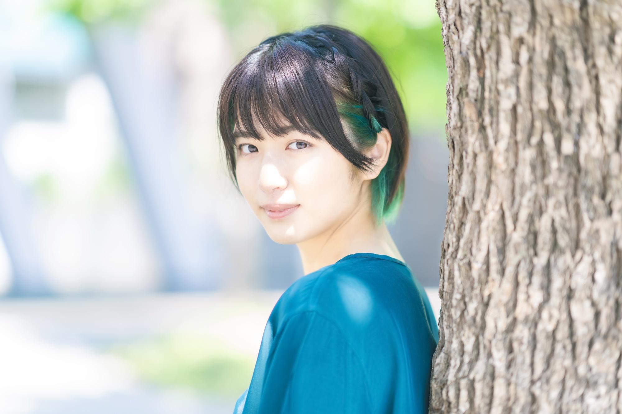 Asian woman with short hair with braids and bangs