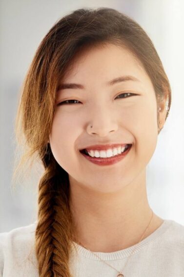 Asian woman with braided long hair with side bangs