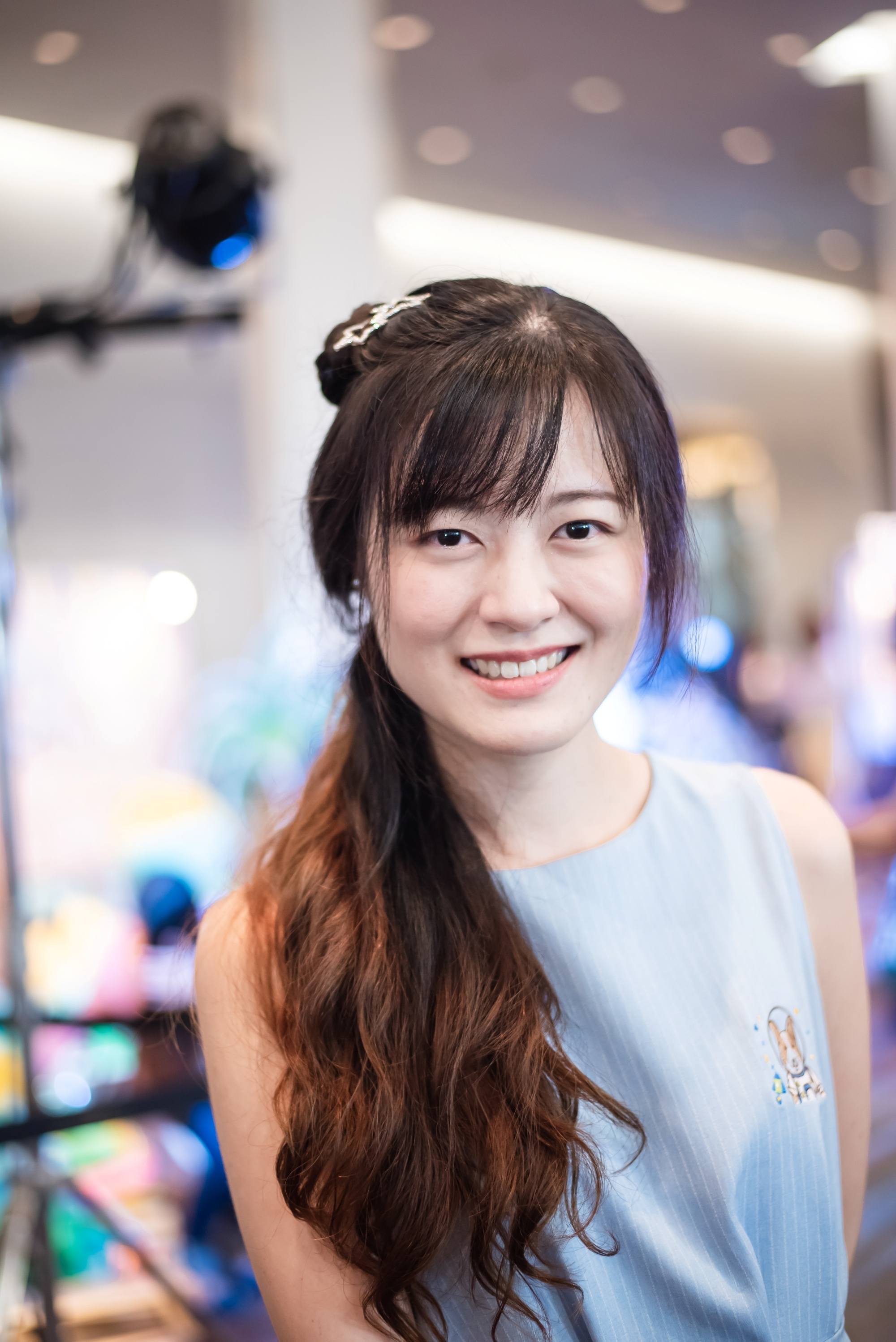 Asian woman with long hair in a ponytail with side-swept bangs for round face