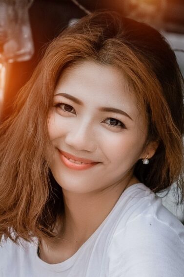 Asian woman with colored hair smiling