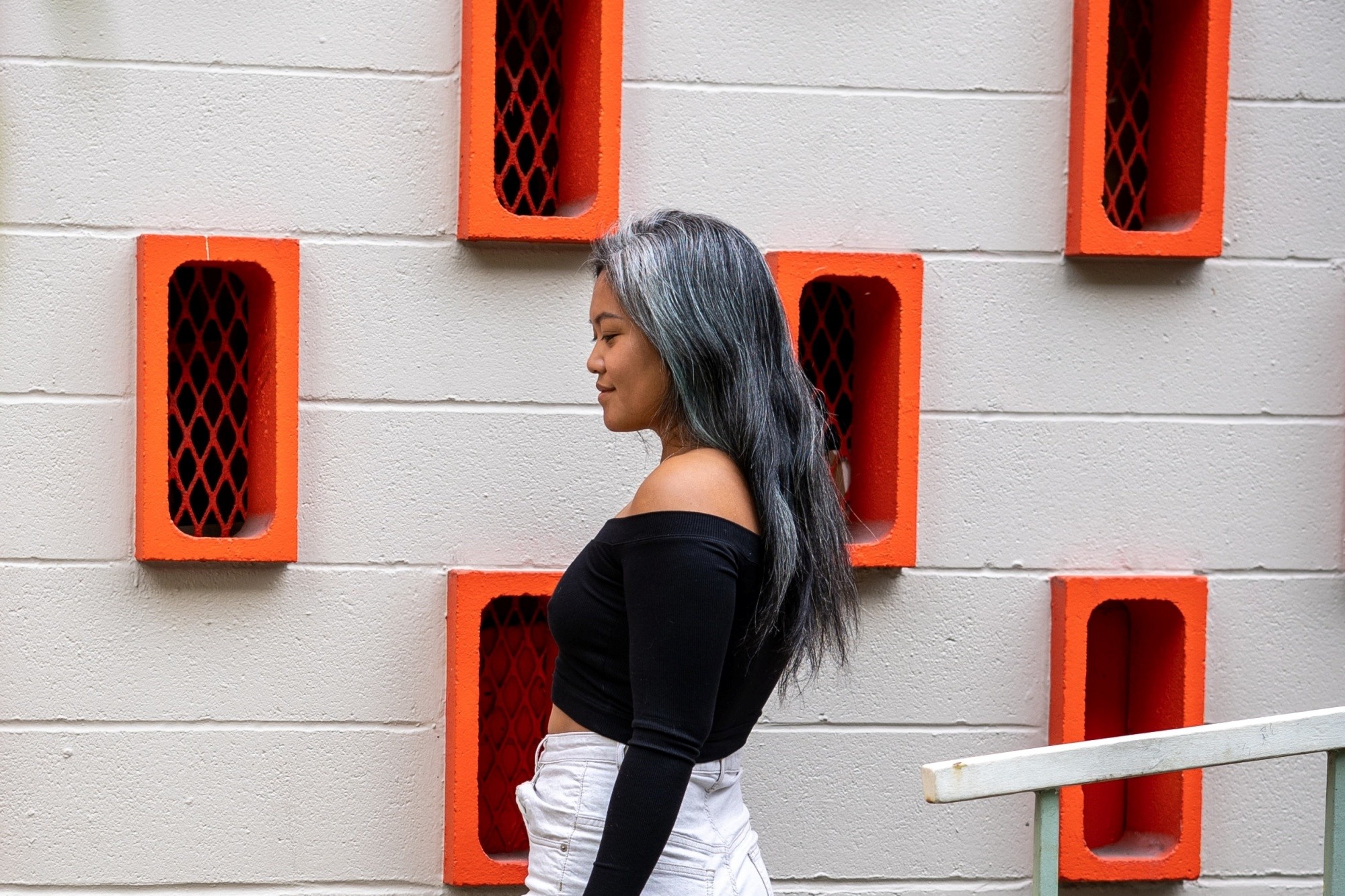 Asian woman with gray hair wearing a black top