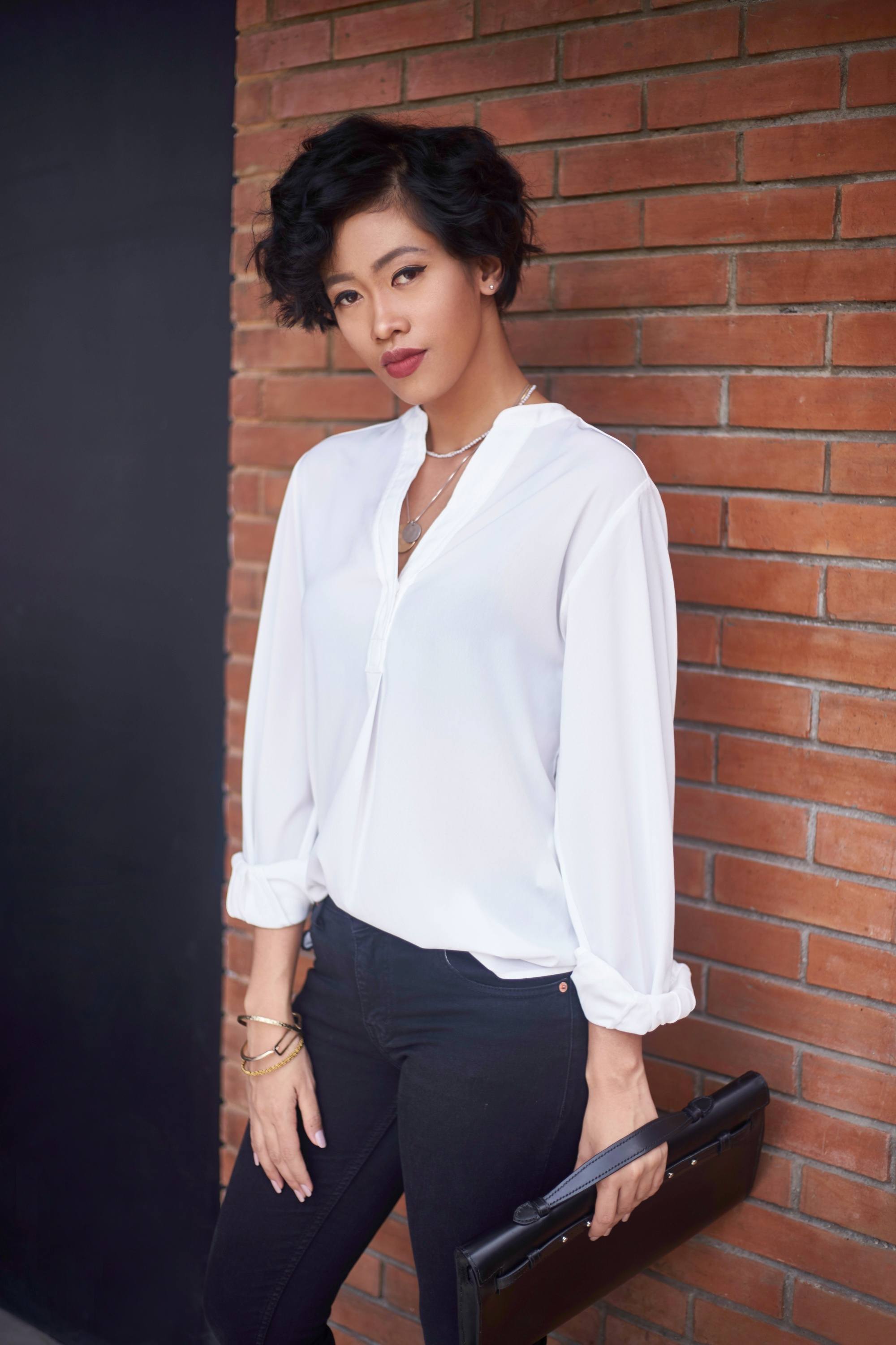 Asian woman with short curly androgynous haircut