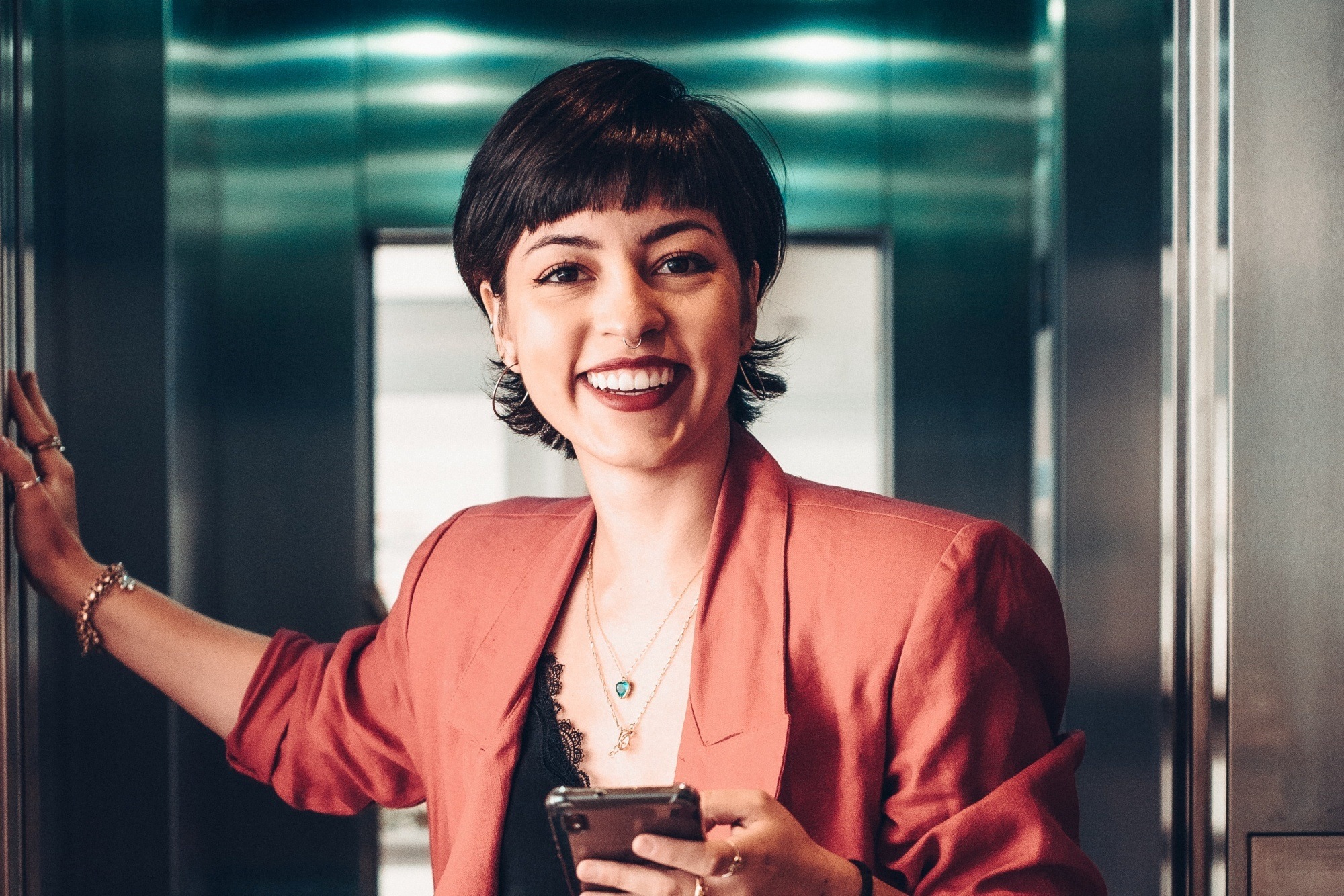 Woman with a mullet haircut wearing a red blazer