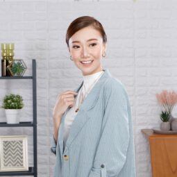 Asian woman wearing a blazer showing an office hairstyle and attire