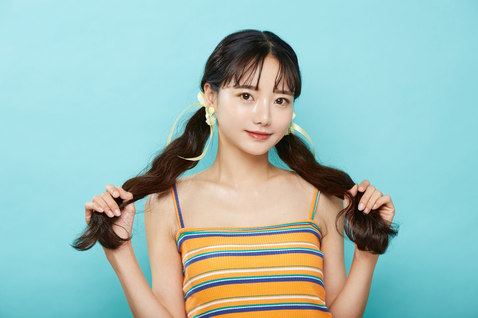 Asian woman with long hair in a pigtail hairstyle