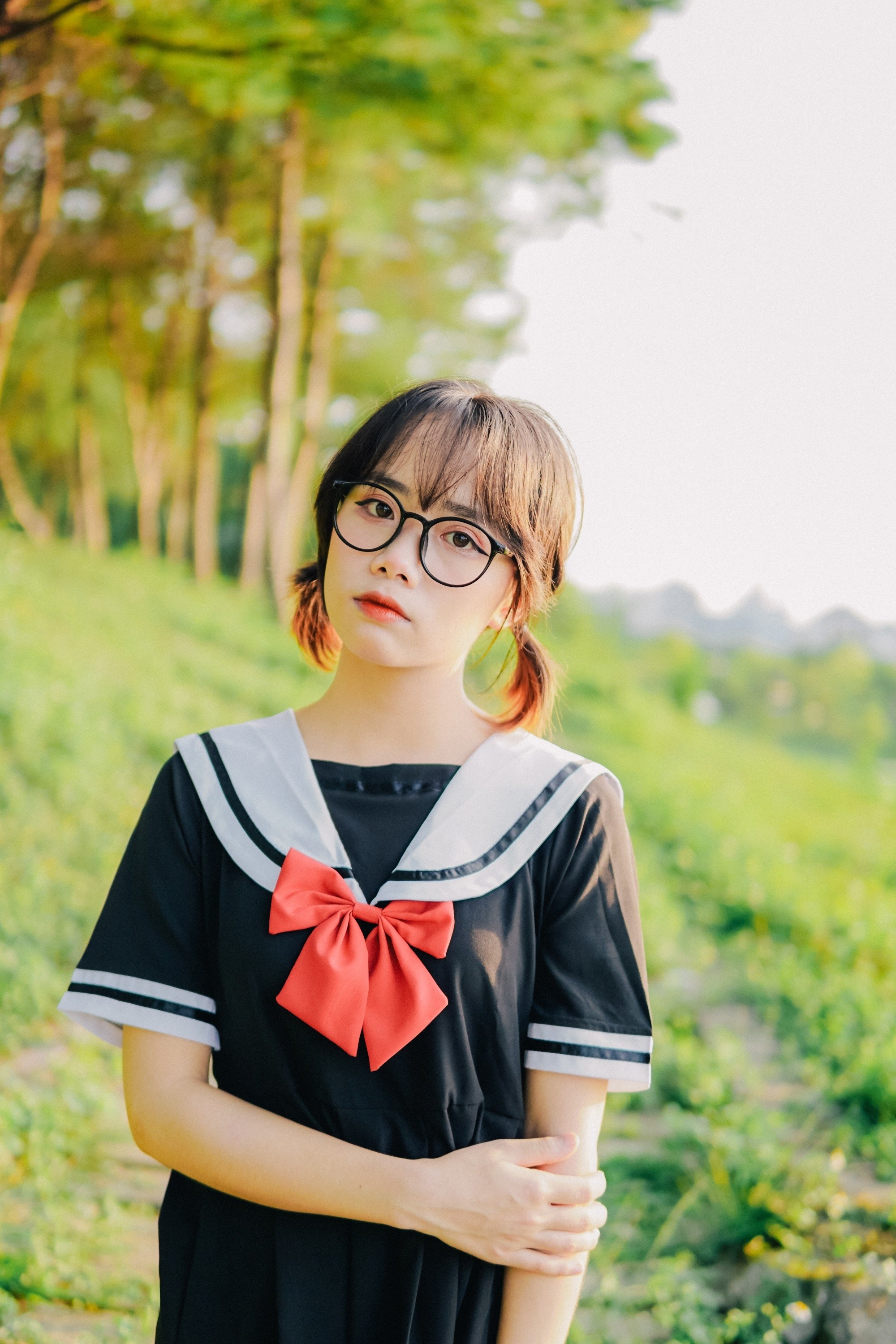 Asian woman with short hair in a low pigtail hairstyle