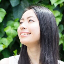 Asian woman standing outdoors and showing off her original hair color