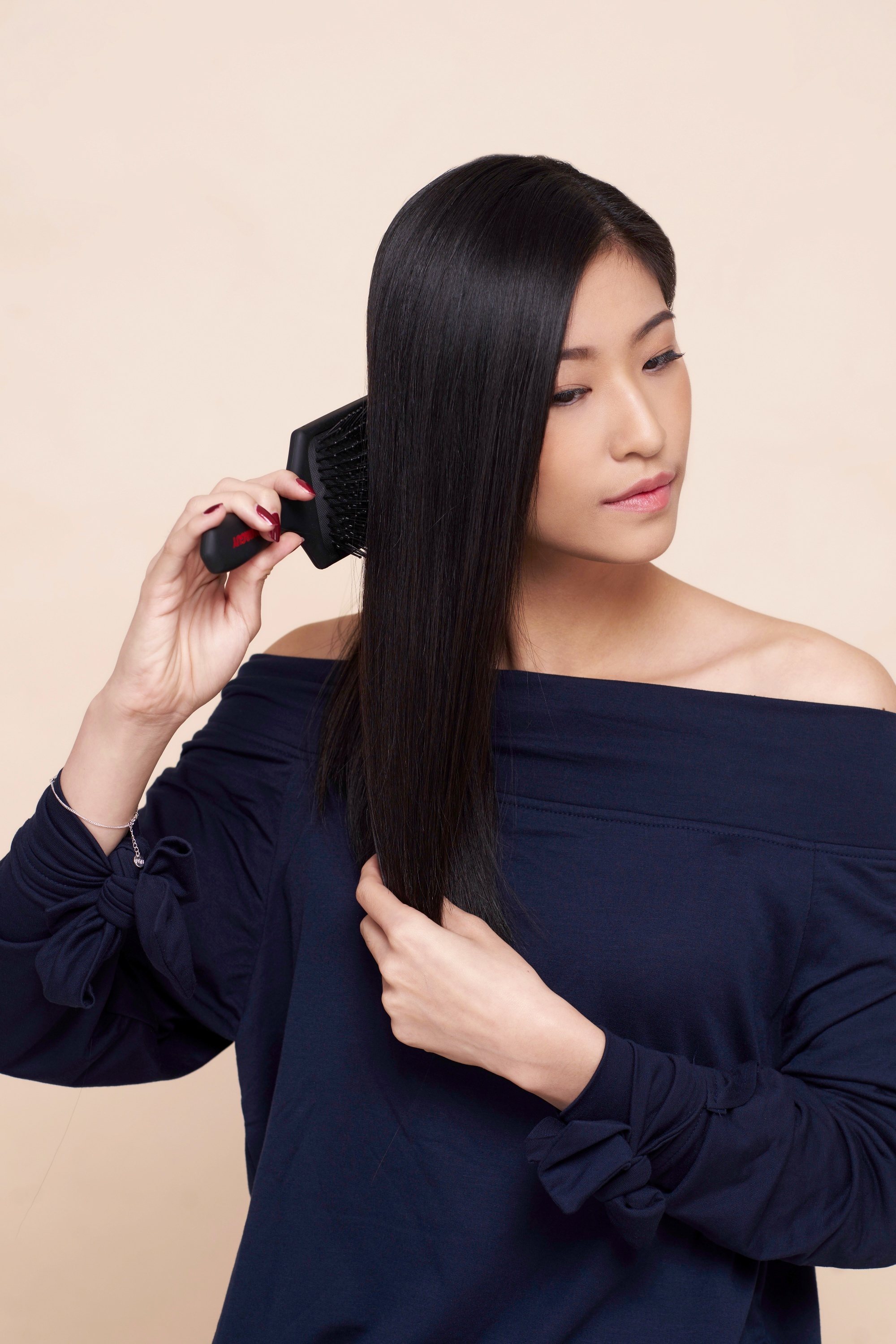 Asian woman brushing her tresses