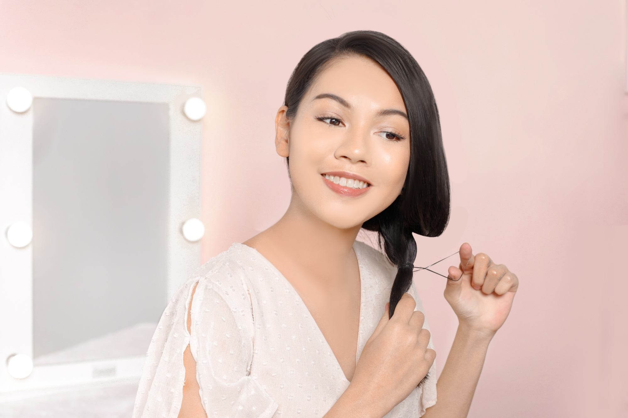 Asian woman styling her hair
