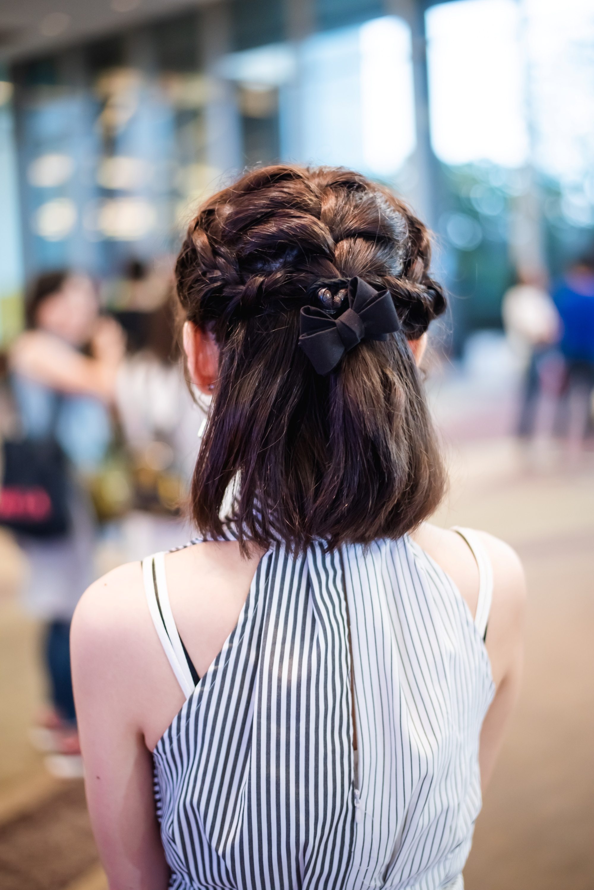 Back shot of an Asian woman with braided short hair