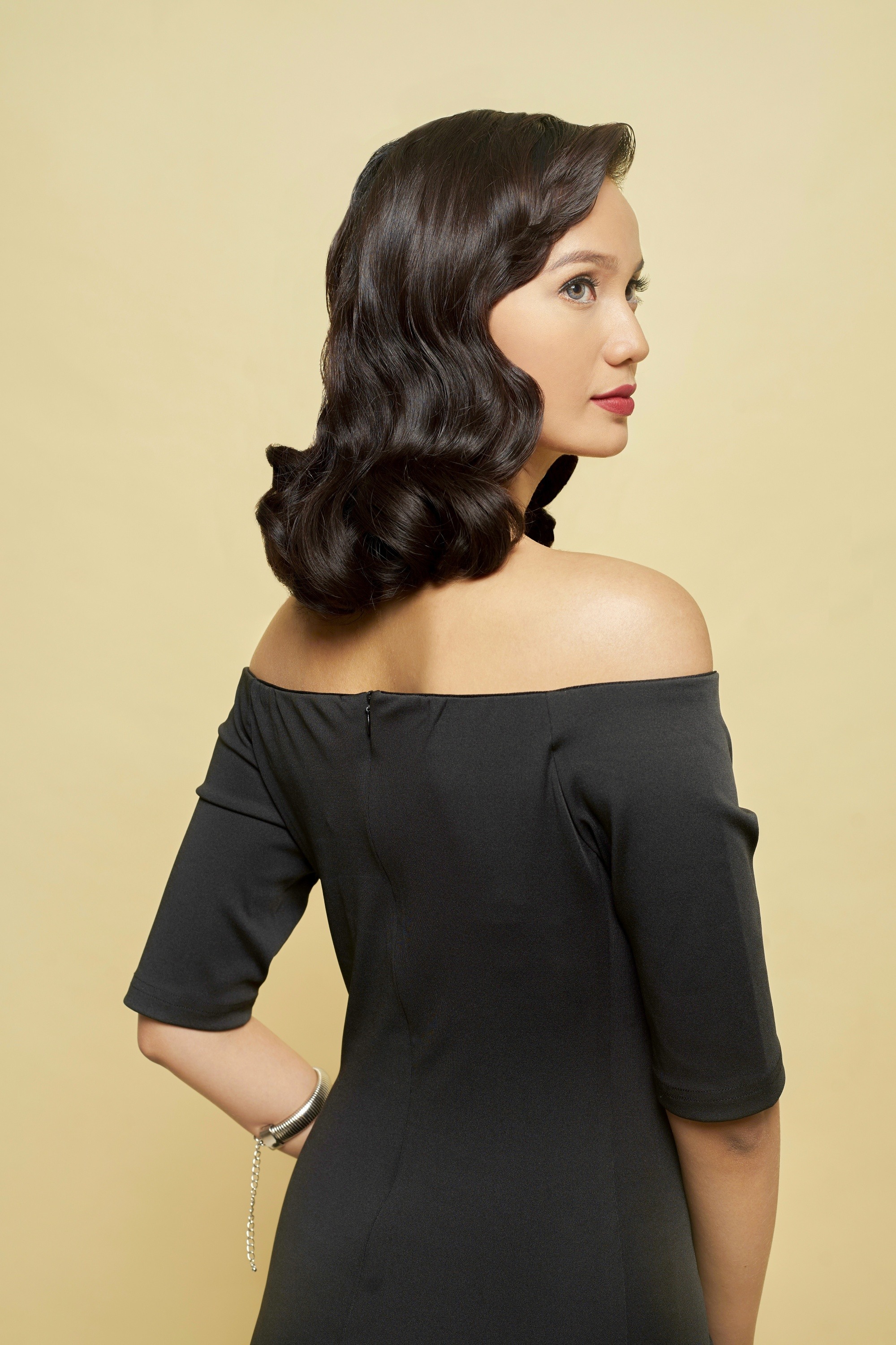 Asian woman with curly shoulder-length hair