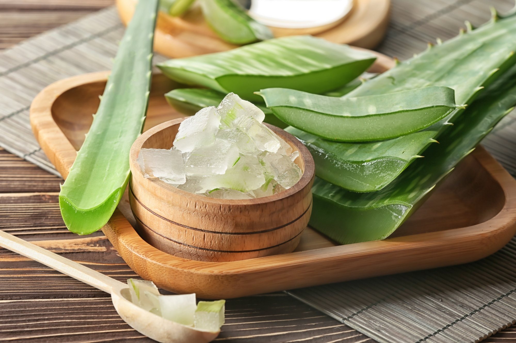 A bottle of tea tree oil and a twig of tea tree leaves on a table