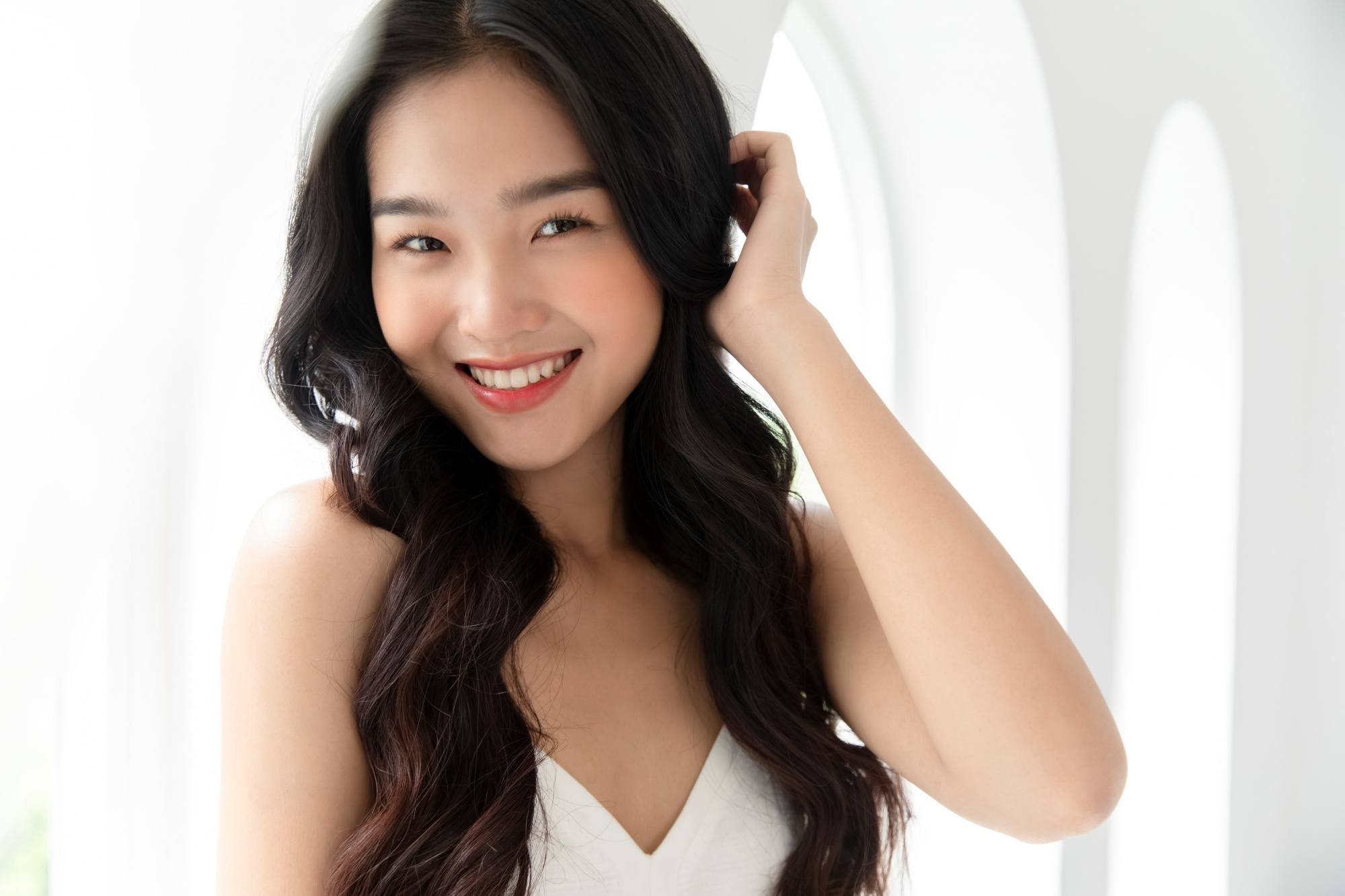 Asian woman with long wavy hair