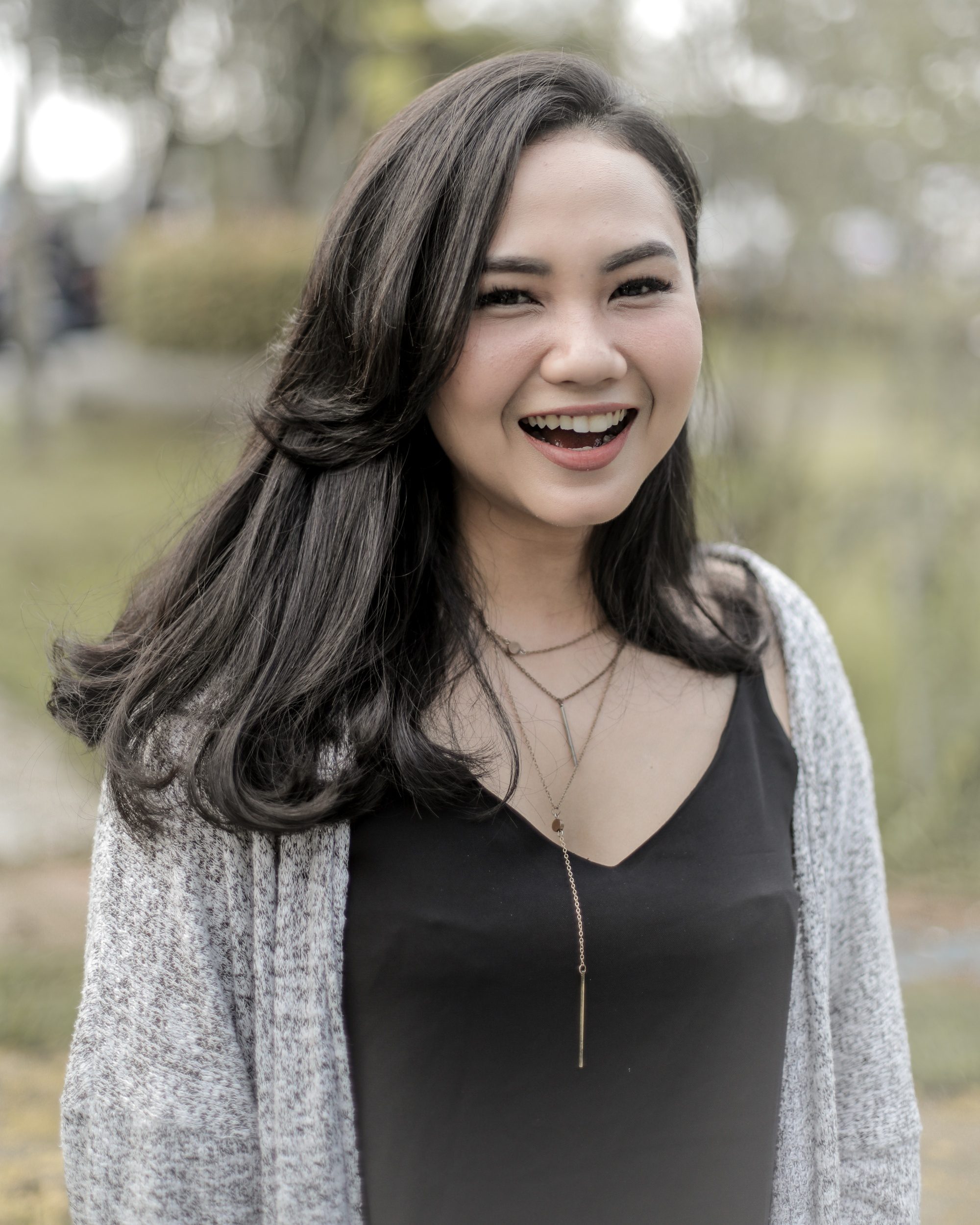 Asian woman with long hair smiling