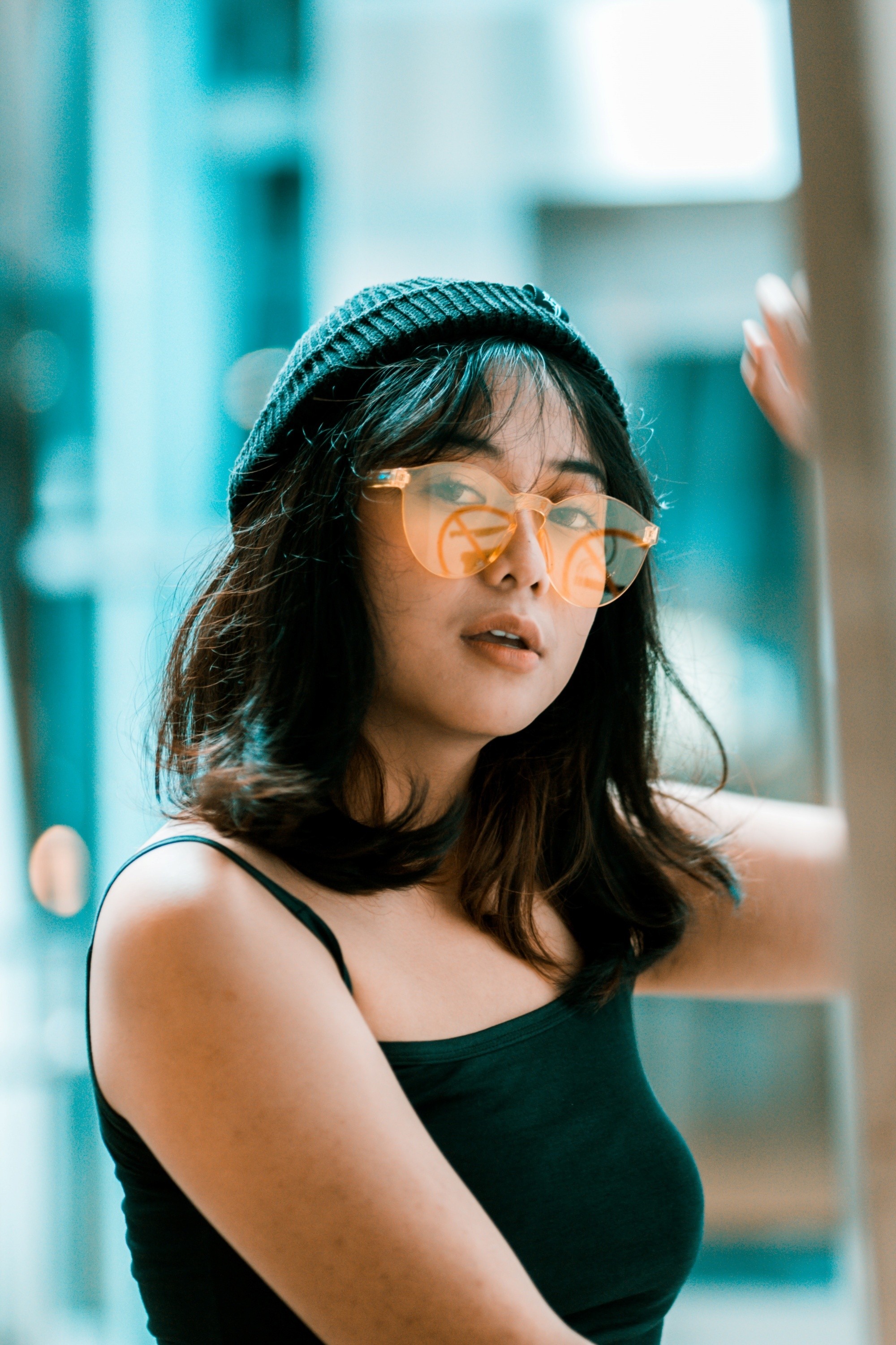 Asian woman with shoulder-length hair and long bangs wearing a bonnet