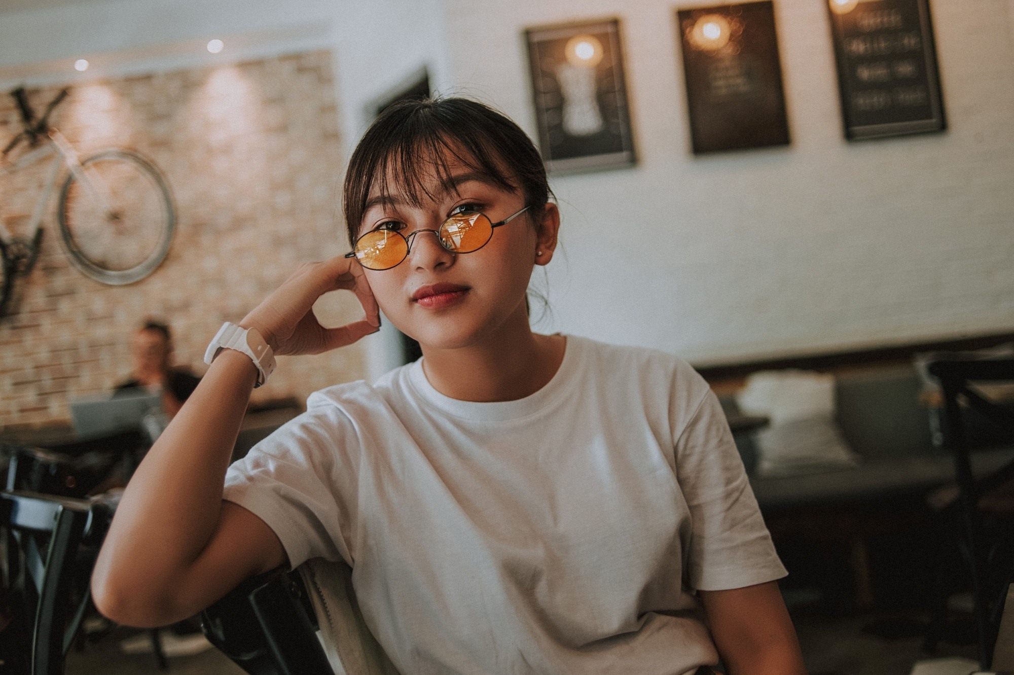 Asian woman with see-through bangs wearing a white shirt