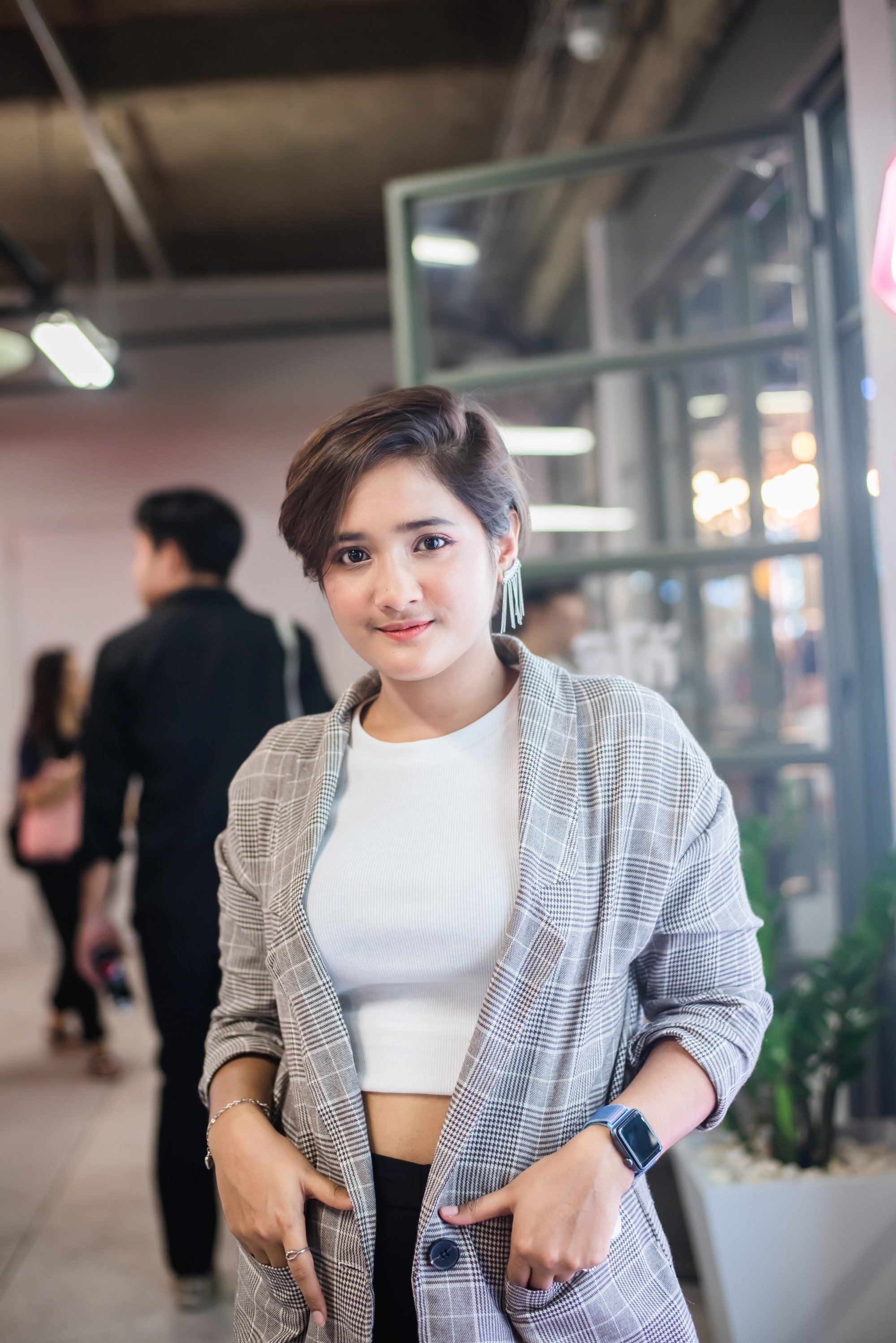 Asian woman with a pixie cut with long bangs
