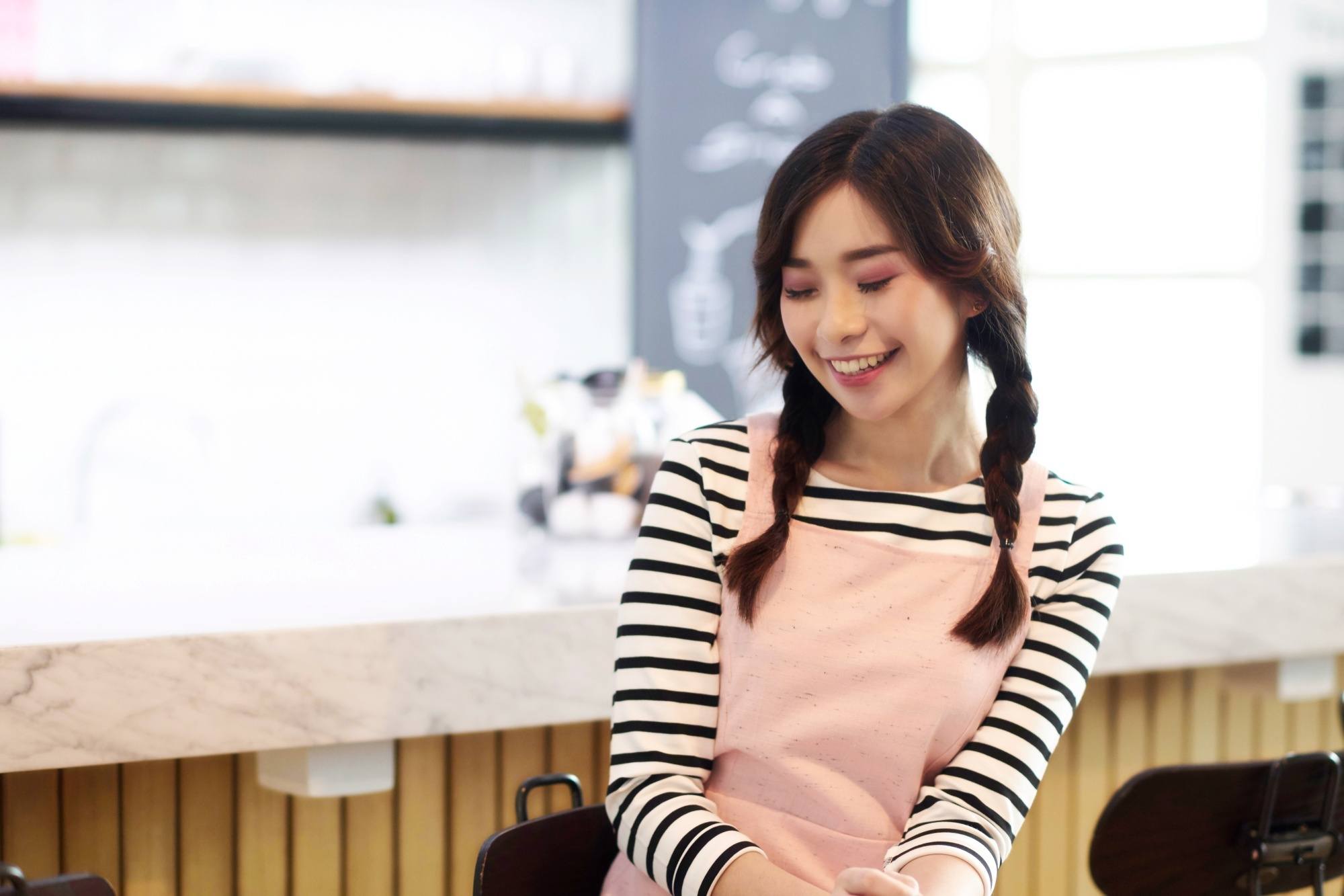 Asian woman with hair in twin braids
