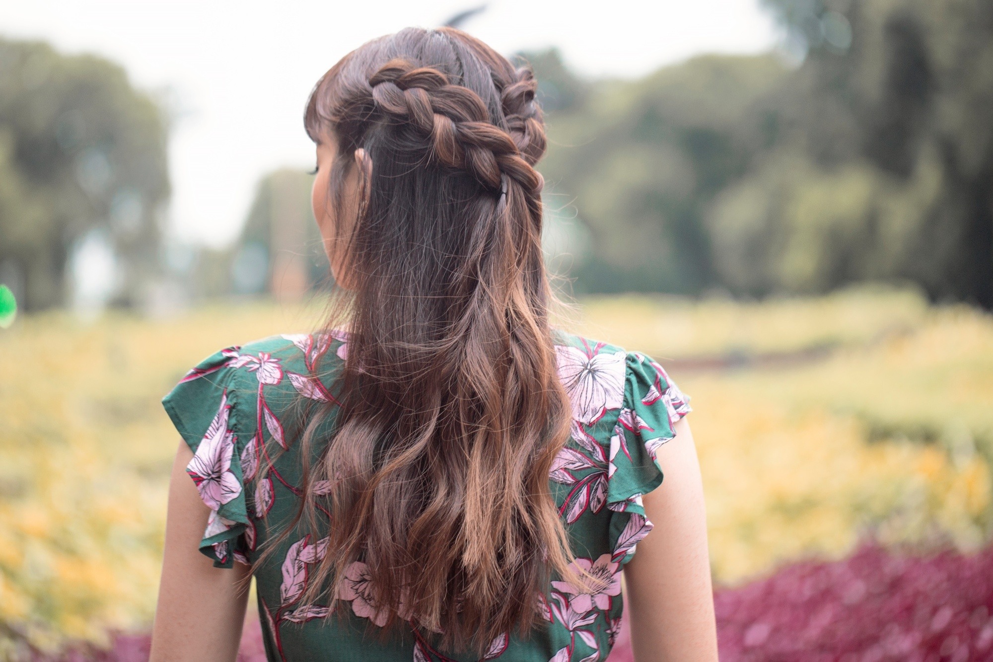 Back shot of an Asian woman with a half-up boho braid