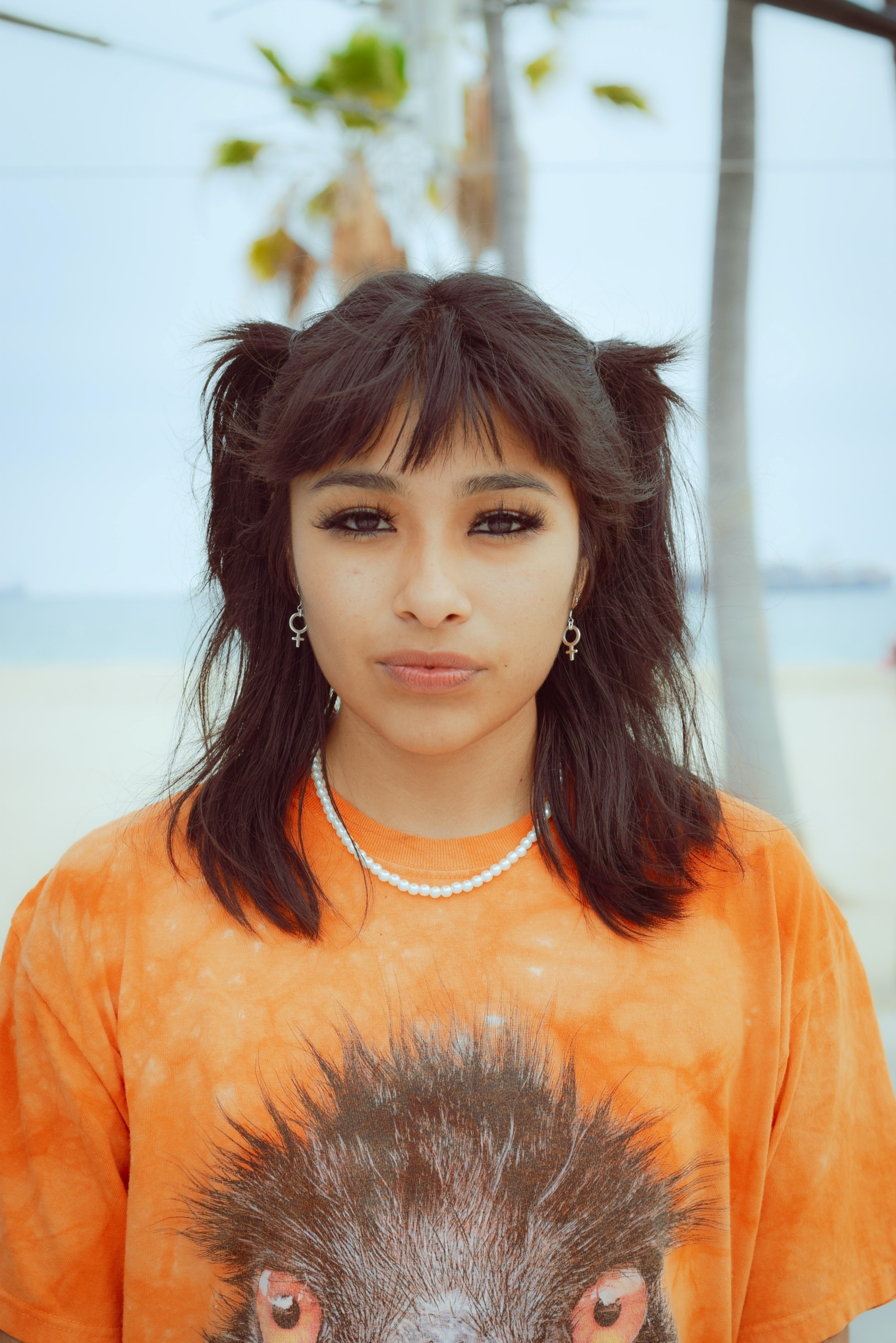 Woman with shoulder-length hair with half-up pigtails wolf cut hairstyle
