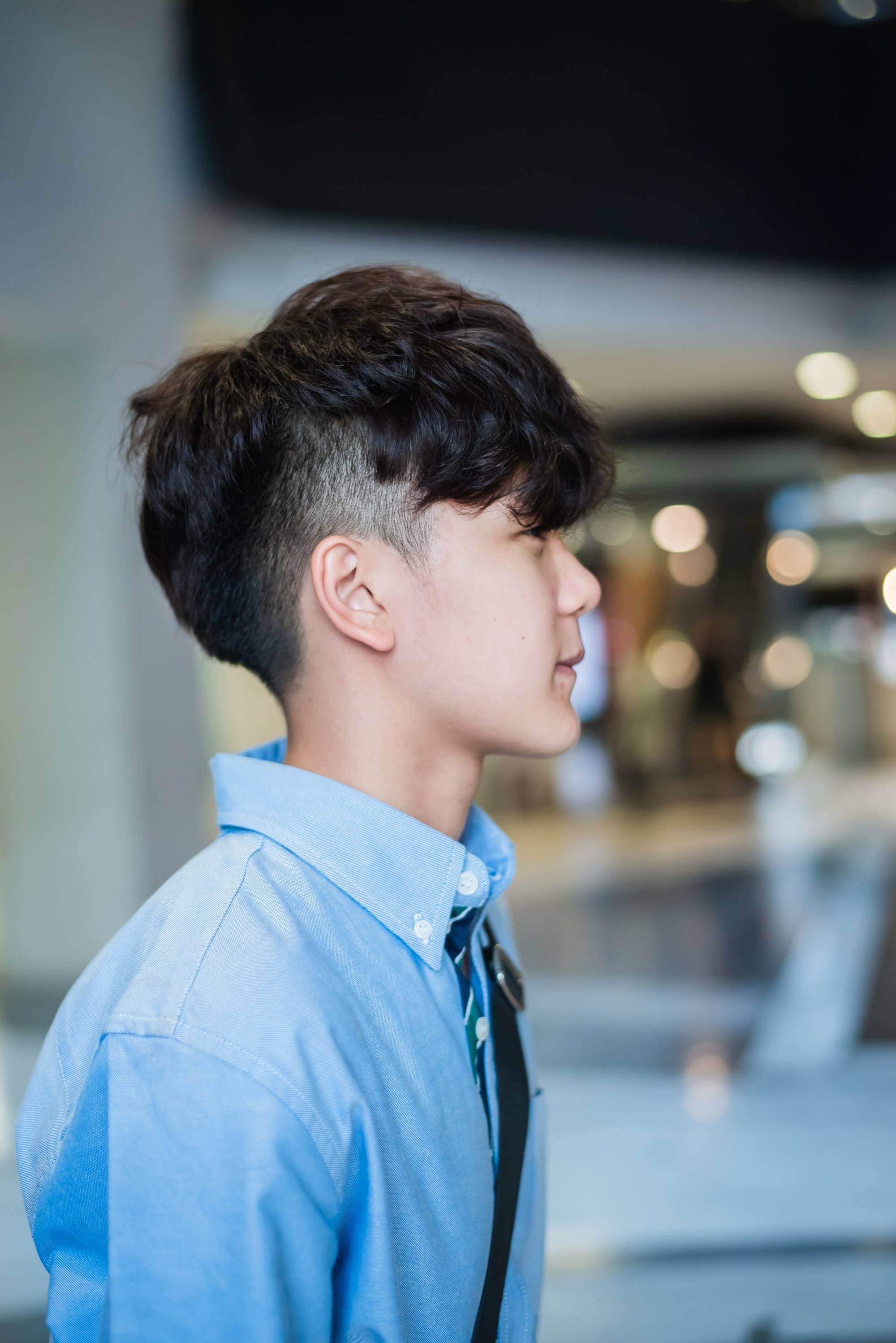 Asian man with a hidden burst fade haircut