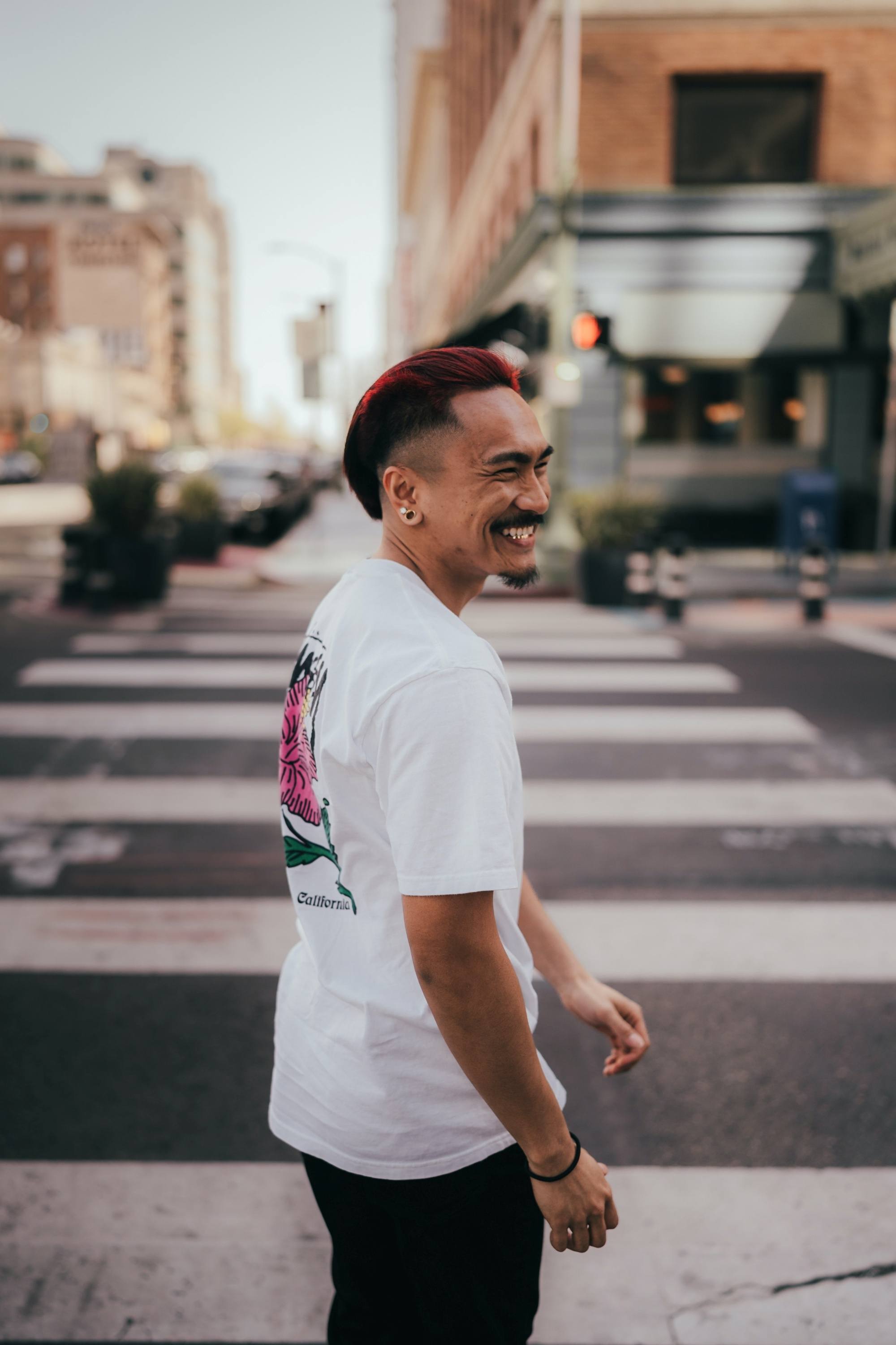 Asian man with slicked-back hair with red streaks