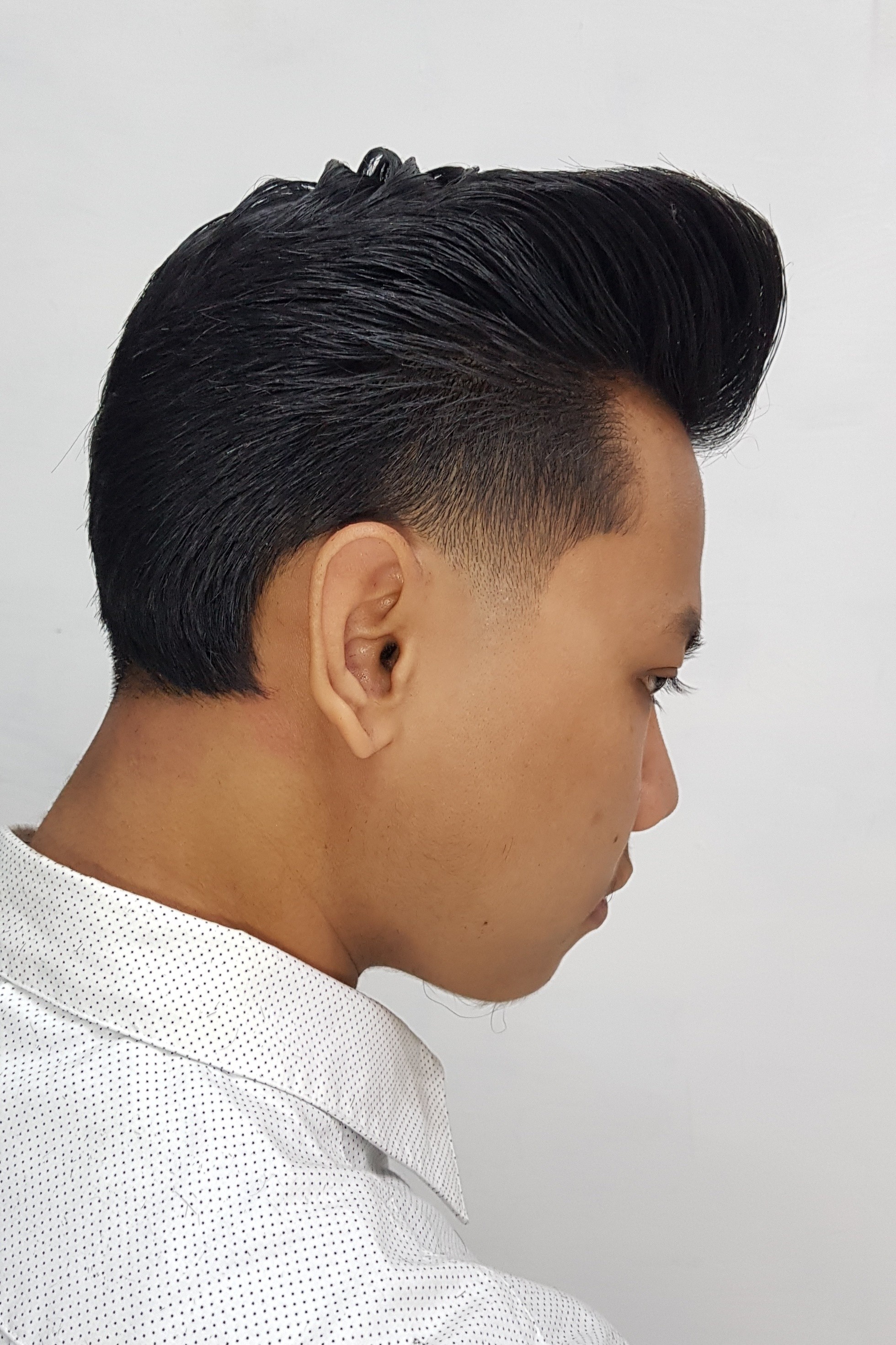 Asian man with a pompadour hairstyle