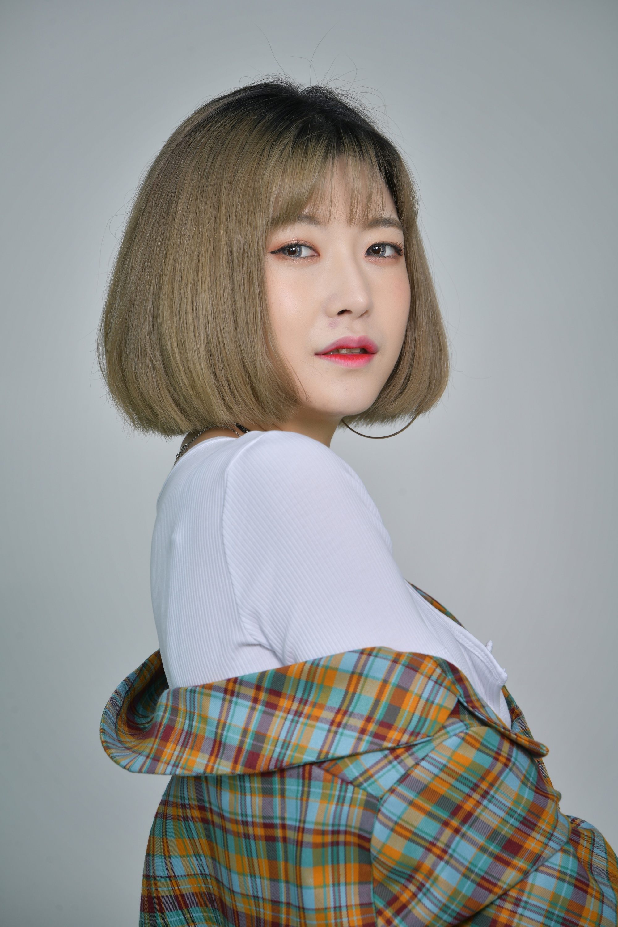 Asian woman with colored hairstyle and bangs