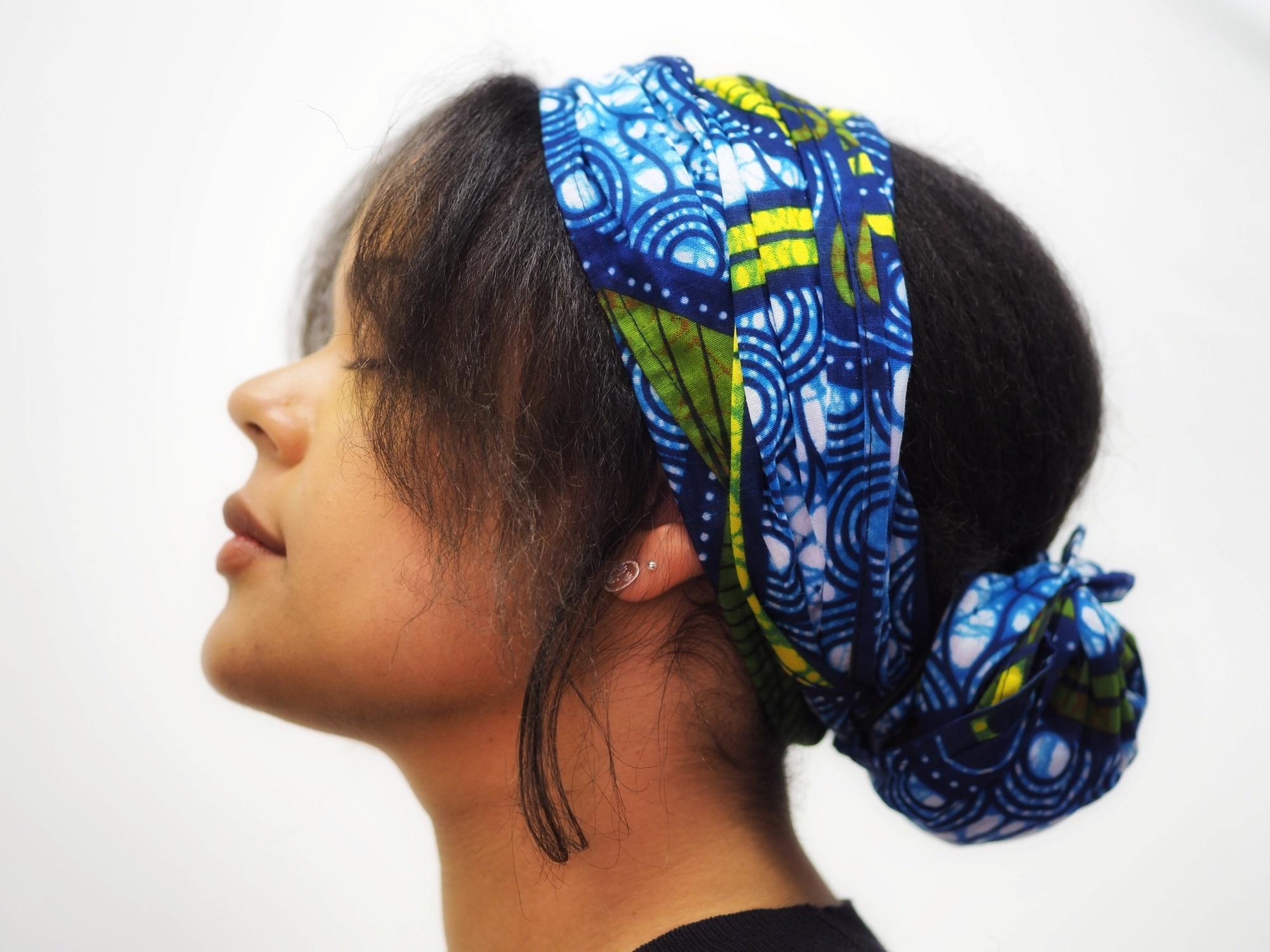 Side view of a woman with a hair bun and bandana
