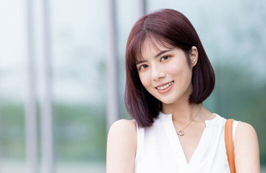 Asian woman with burgundy hair color