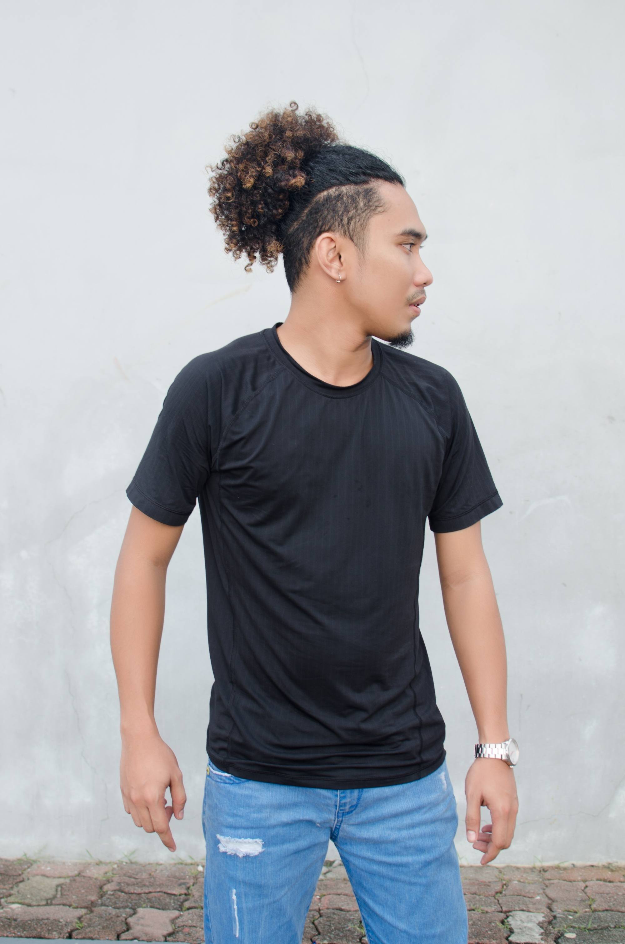 Asian man with curly hair and a long hair undercut