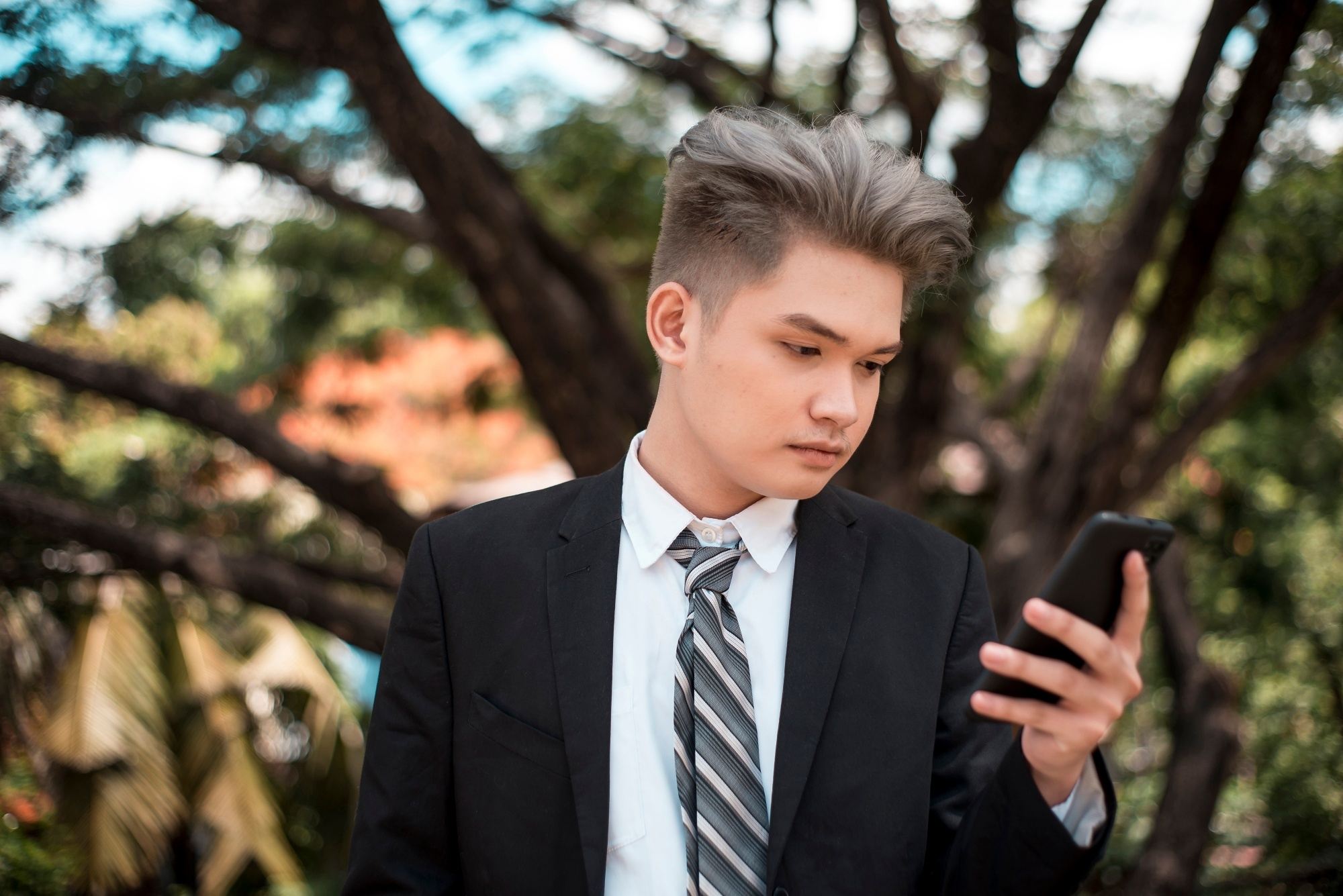 Asian man with gray long hair undercut