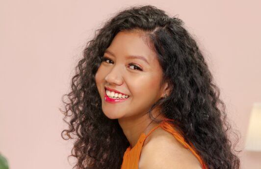 Asian woman with curly hair posing for a hair perm concept
