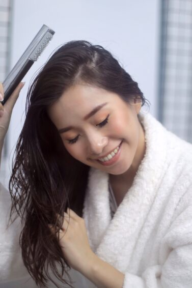 Asian woman water-washing her hair