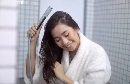 Asian woman water-washing her hair