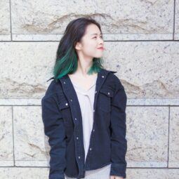 Asian woman with a green underlayer hair color