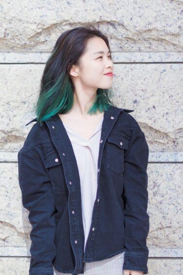 Asian woman with a green underlayer hair color
