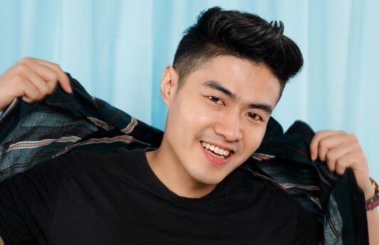 Asian man with a mohawk haircut with feathered hairstyle