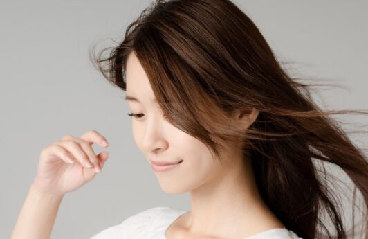 Asian woman with long hair posing for a hair care concept