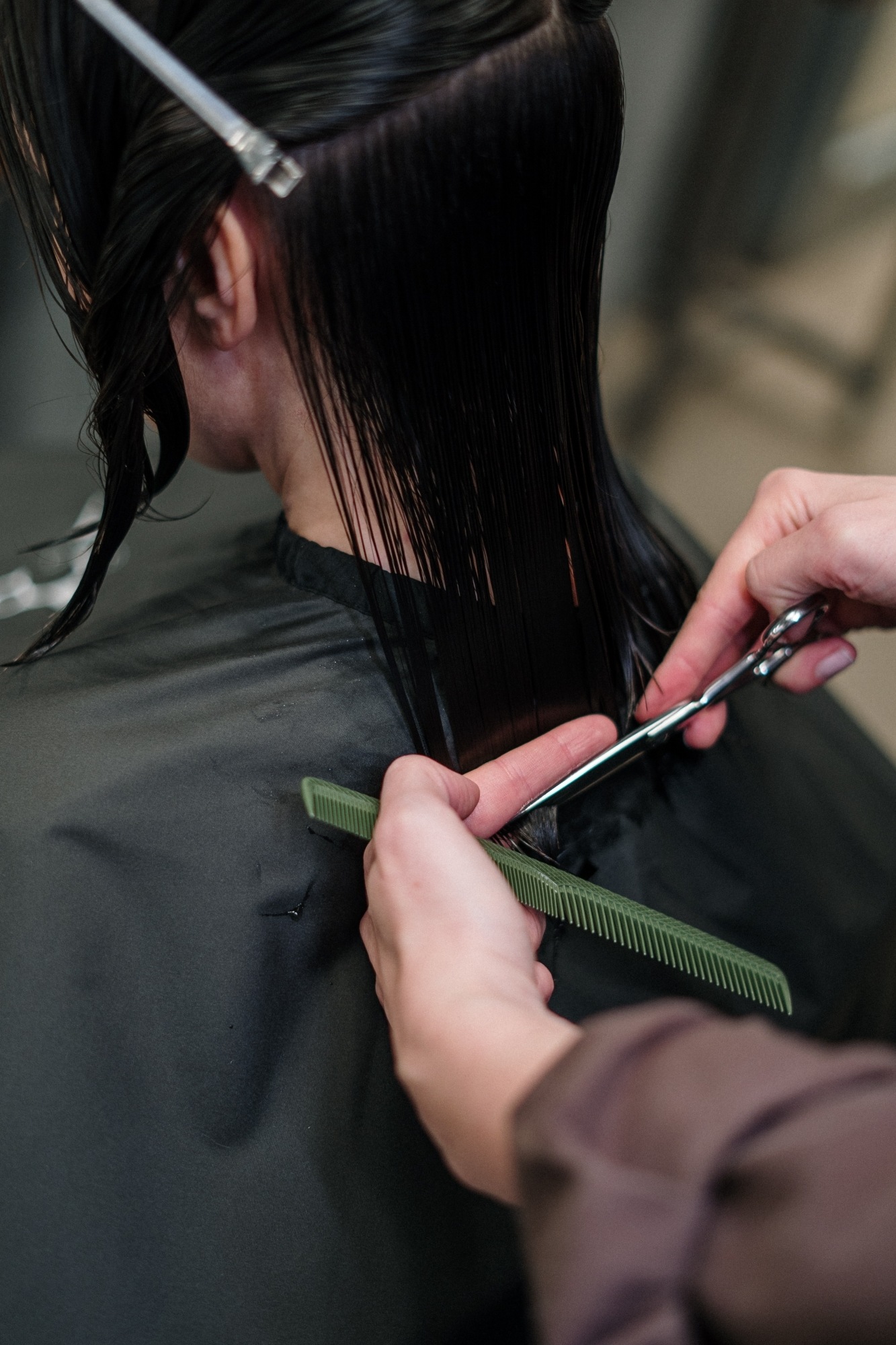 Asian woman getting a haircut