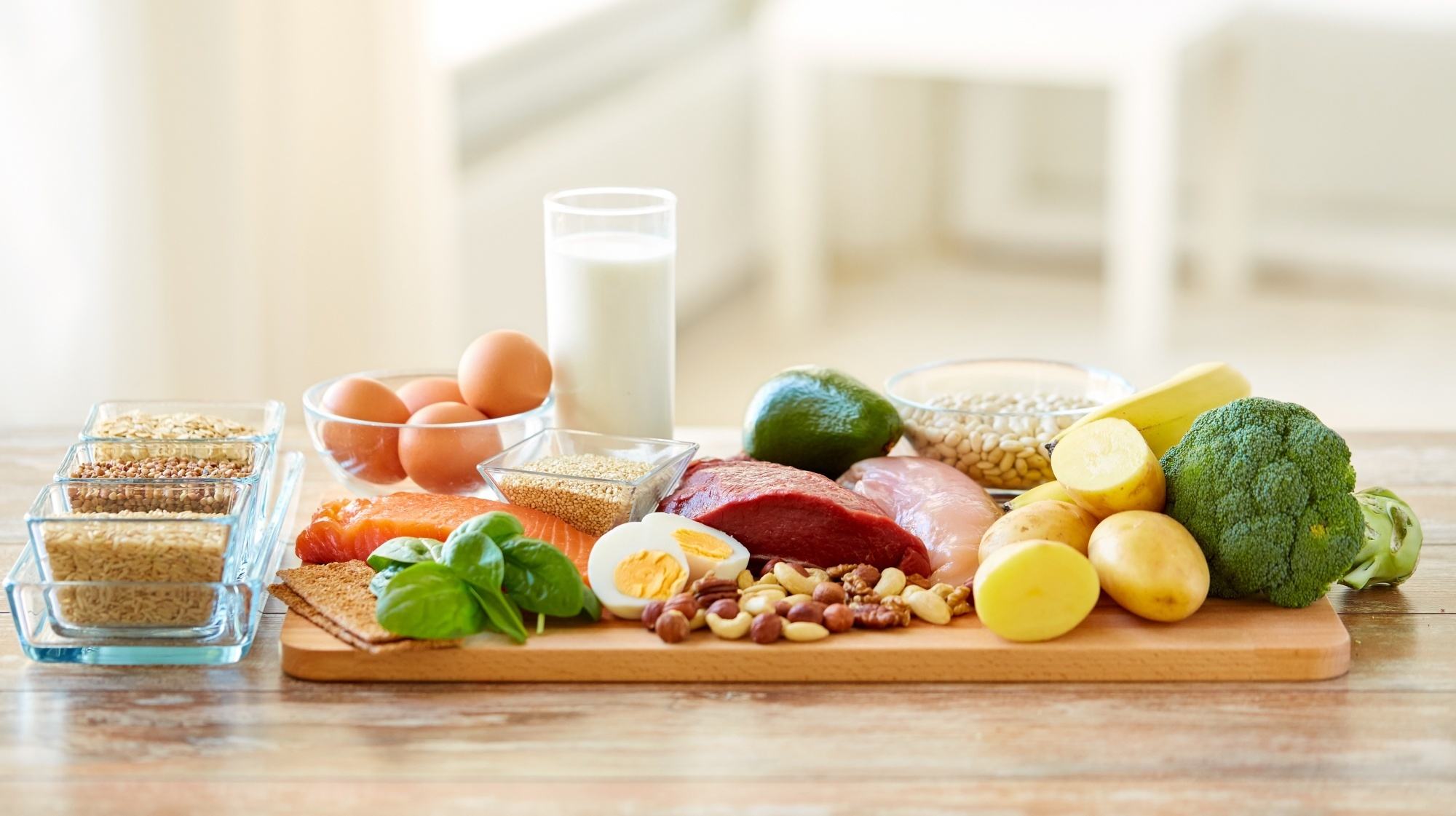 Vegetables, milk, eggs, and meat on a table