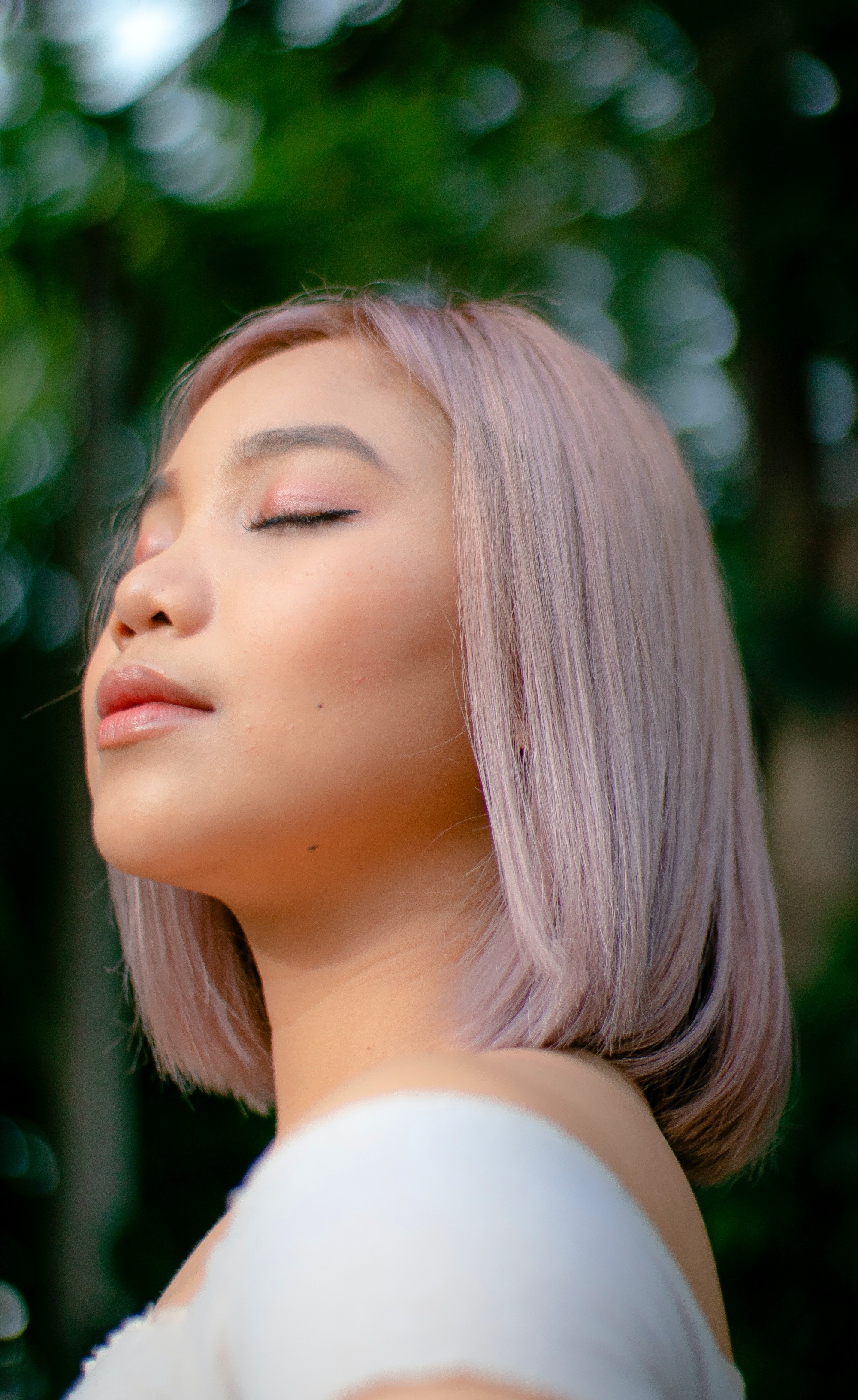 Asian woman with a dusty pink Korean hair color